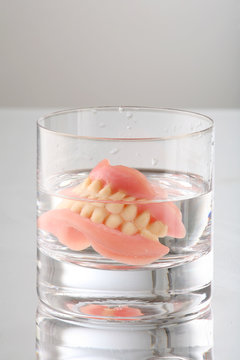 artificial Teeth on glass with water