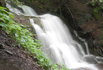 Obraz premium The prompt mountain river with falls