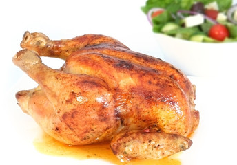 Golden roasted chicken, with bowl of Greek salad.  