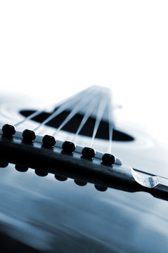 Acoustic guitar close up on white background