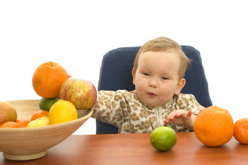 Fototapeta premium Baby and fresh fruits on table isolated background