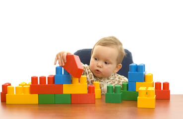 Cute baby girl with colorful blocks isolted background