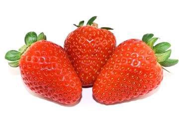 Three strawberries closeup isolated on white