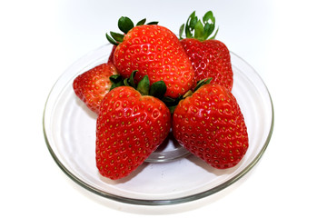 Strawberries on plate over white background