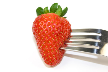 Strawberry on fork isolated on white