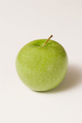 a single green apple on a white background
