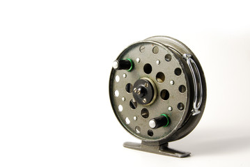 An old fishing reel on a white background