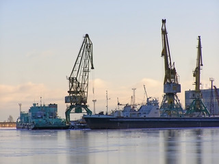 Fototapeta premium winter cargo side port with big ships and cranes