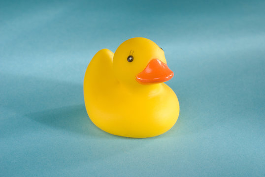 a rubber duck on an aqua blue background