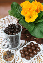 Brown sugar, coffe beans, chocolates and a flower.