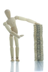 Manikin pointing to coins pile with hand