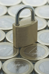 Euro coins pattern and locked padlock
