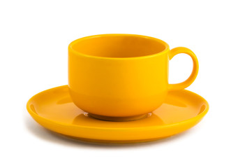 Simple yellow coffee cup and saucer on white background