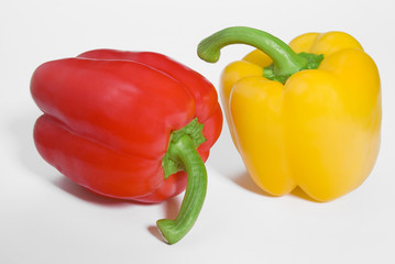 Two ripe peppers on white background with shadows