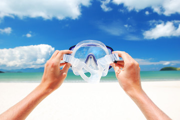 Snorkel equipment against beach and sky
