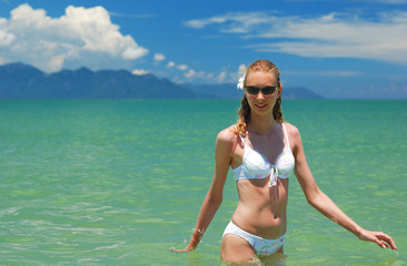 Girl on a tropical beach in the sea