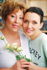 Mother embracing her young beautiful daughter