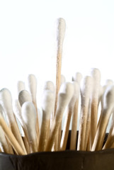 detail of group of cotton tipped applicators one sticking out