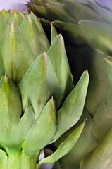 Close up of an artichoke reflected in stainless steel.