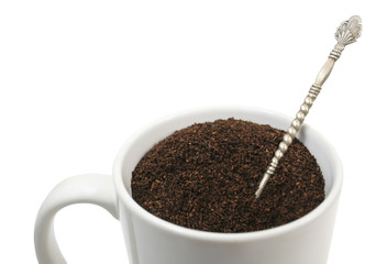 View of a white cup of ground coffee over white