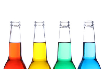 bottles with red, yellow, green, and blue liquids isolated