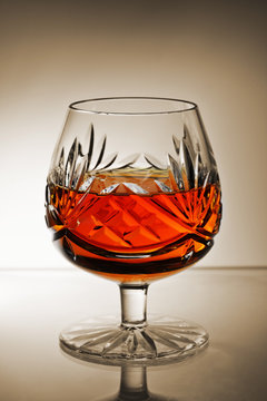brandy snifter glass with gradient sepia background