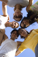 Obraz premium Group of young happy people with heads together