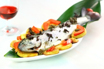 Fresh rainbow trout and glass of red wine