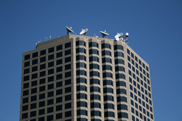 satellite dishes on skyscraper