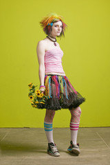 Pretty young woman with colorful clothes with plastic flowers.
