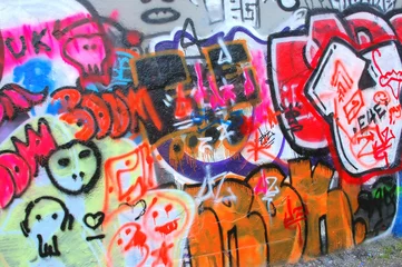 Papier Peint photo Graffiti Graffiti on a city wall outdoors.