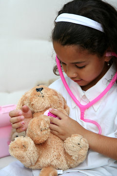 Young Girl Plays Doctor Or Nurse With Stuffed Animal