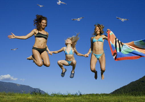 two girls having fun with a child.