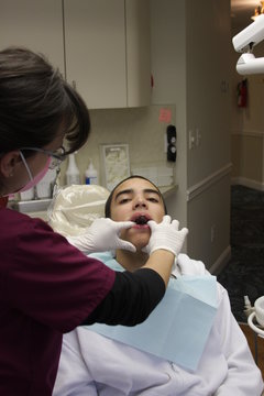 teenager in the dentist's chair after braces are removed 