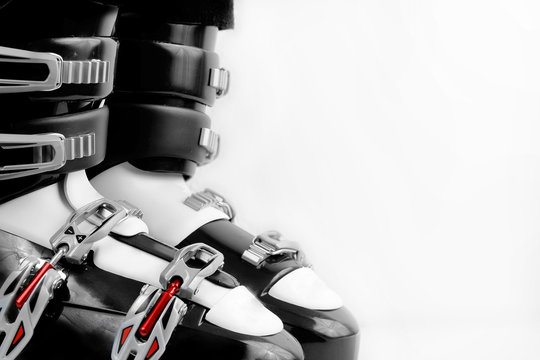 Black And Red Ski Boots Over White Background