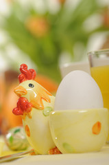 a detail of an easter breakfast table with a close-up of an egg