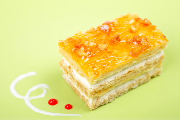 Delicious cake with soft shadow on green dish. Shallow DOF