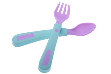 crossed fork and spoon on white