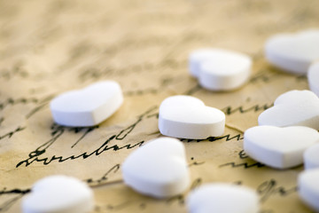 little white peppermint hearts on handwritten letter