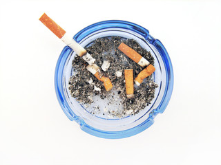 Blue glass ashtray with cigarette
