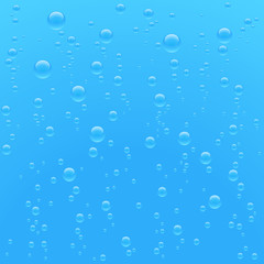 air bubbles floating in blue clear water