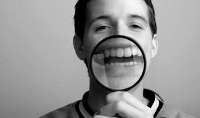 Psychology fun concept.  Man and magnifier on his smile