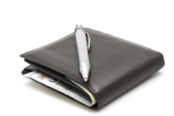 Silver pen on wallet with eouro money