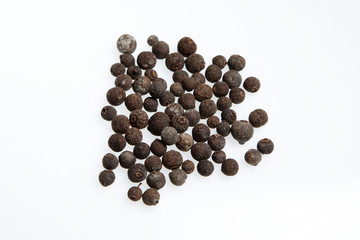 allspice balls isolated against a white background