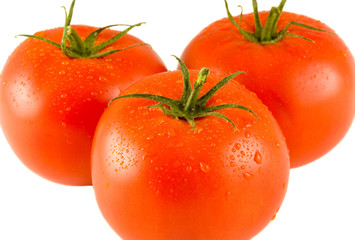 three full tomatoes with water drops