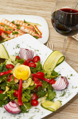 colorful salad with shrimp and red wine at the restaurant