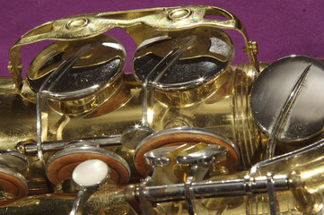 Saxophone against purple, alto, lowest keys and key mechanism