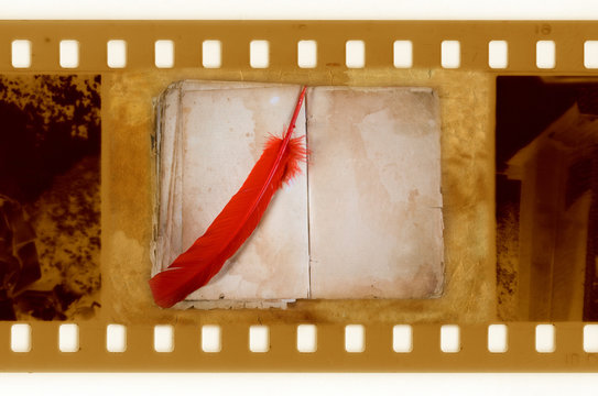 old 35mm frame photo with vintage book and feather