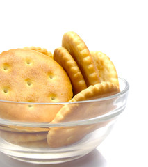 Salt crackers food  in the glass vase isolated over white 