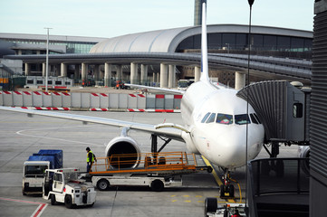 Airport staff around the plane prepping for the next flight.